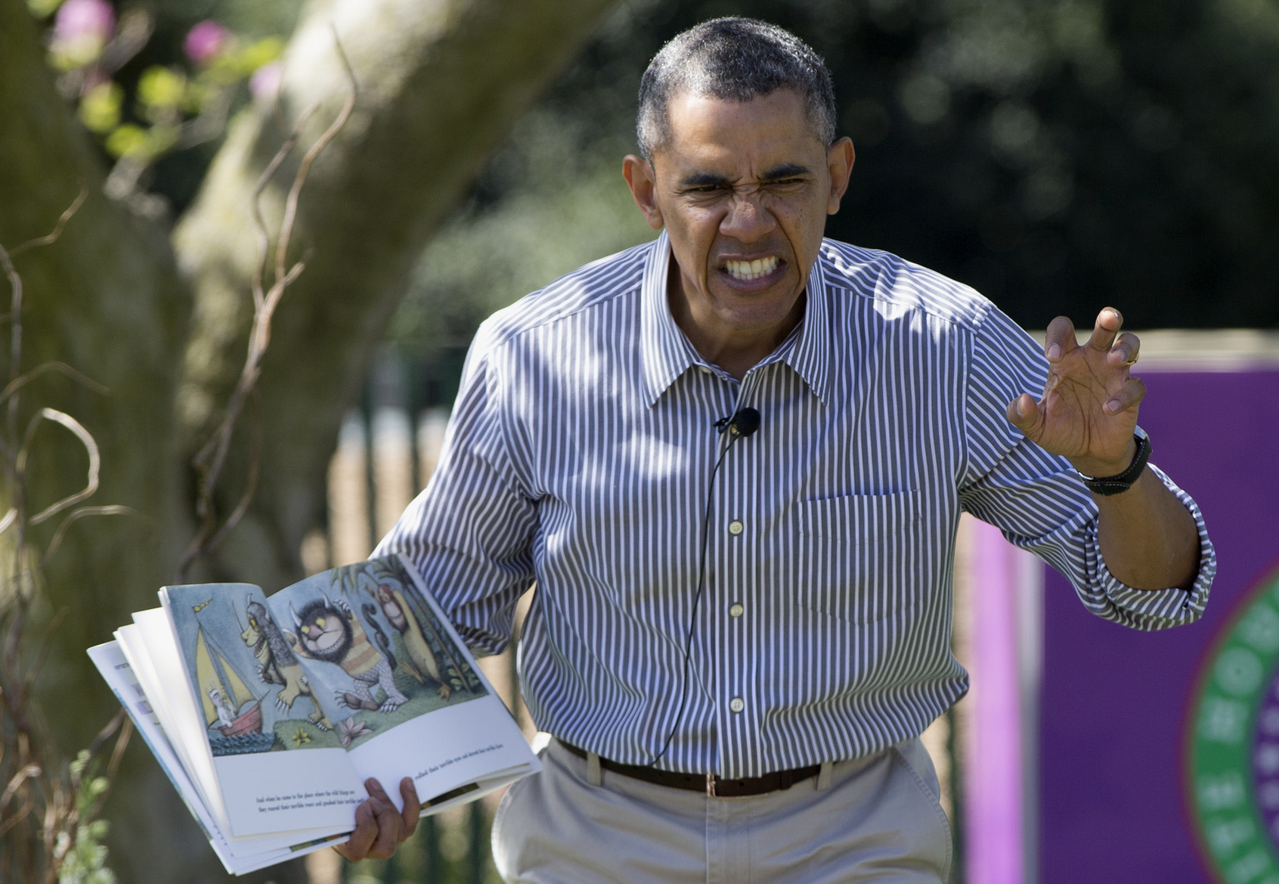FOR USE AS DESIRED, YEAR END PHOTOS - FILE - President Barack Obama makes a face as he reads &quot;Where the Wild Things Are&quot; by Maurice Sendak, during the White House Easter Egg Roll on the South Lawn of the White House is Washington, Monday, April 21, 2014. Thousands of children gathered at the White House for the annual Easter Egg Roll. This year's event features live music, cooking stations, storytelling, and of course, some Easter egg rolling. (AP Photo/Carolyn Kaster, File)