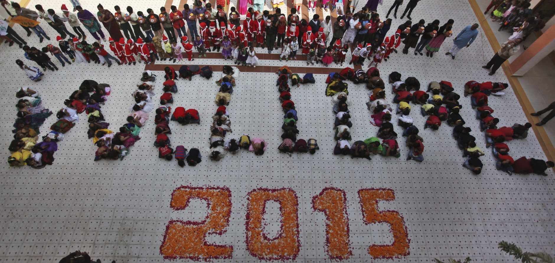 Indian students form numbers representing the year 2015 during a function to welcome the New Year at a school in Ahmadabad, India, Wednesday, Dec. 31, 2014. (AP Photo/Ajit Solanki)