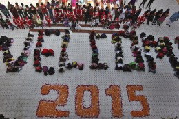 Indian students form numbers representing the year 2015 during a function to welcome the New Year at a school in Ahmadabad, India, Wednesday, Dec. 31, 2014. (AP Photo/Ajit Solanki)