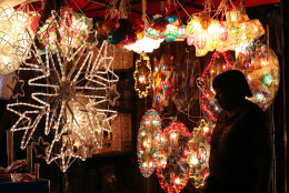 A Filipino woman looks at Christmas lanterns for sale in Manila, Philippines on Monday, Dec. 22, 2014. Christmas is one of the most important holidays in this predominantly Roman Catholic nation. (AP Photo/Aaron Favila)