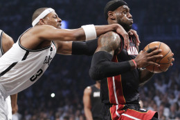 FOR USE AS DESIRED, YEAR END PHOTOS - FILE - Brooklyn Nets forward Paul Pierce (34) fouls Miami Heat forward LeBron James (6) as he drives through the lane to score in the first period during Game 3 of an Eastern Conference semifinal NBA playoff basketball game on Saturday, May 10, 2014, in New York. Pierce was called for a flagrant foul and James scored on the play. (AP Photo/Julie Jacobson, File)