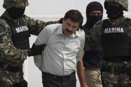 FOR USE AS DESIRED, YEAR END PHOTOS - FILE - In this Saturday, Feb. 22, 2014 photo, Joaquin &quot;El Chapo&quot; Guzman is escorted to a helicopter in handcuffs by Mexican navy marines at a navy hanger in Mexico City, Mexico. Guzman, the head of Mexico's Sinaloa Cartel, was captured alive overnight in the beach resort town of Mazatlan. (AP Photo/Eduardo Verdugo, File)