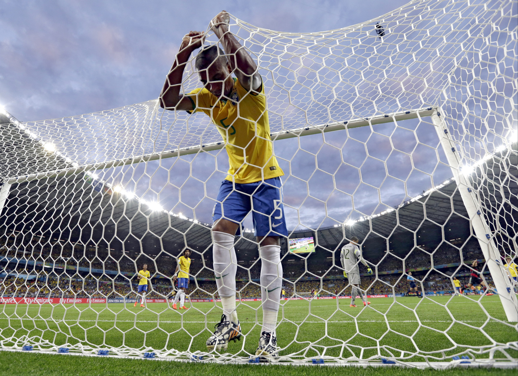 FOR USE AS DESIRED, YEAR END PHOTOS - FILE - Brazil's Fernandinho reacts after Germany's Toni Kroosduring scored his side's third goal during the World Cup semifinal soccer match between Brazil and Germany at the Mineirao Stadium in Belo Horizonte, Brazil, Tuesday, July 8, 2014. (AP Photo/Natacha Pisarenko, File)