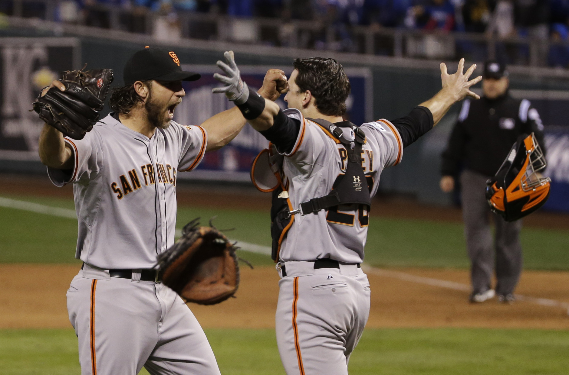 FILE - In this Oct. 29, 2014, file photo, San Francisco Giants pitcher Madison Bumgarner, left, and Buster Posey celebrate after winning 3-2 to win the series over Kansas City Royals after Game 7 of baseball's World Series in Kansas City, Mo. (AP Photo/Matt Slocum, File)