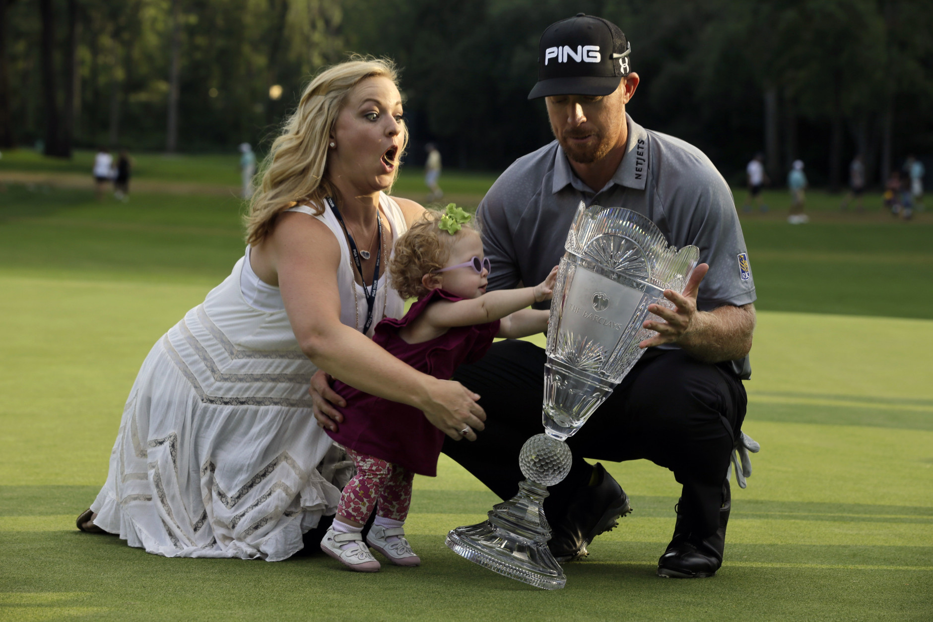 FOR USE AS DESIRED, YEAR END PHOTOS - FILE - Zoe Mahan, center, pushes the trophy as her mother Kandi  Mahan, left, grabs her while they pose with Hunter Mahan, husband,  father and winner of The Barclays golf tournament Sunday, Aug. 24, 2014, in Paramus, N.J. (AP Photo/Mel Evans, File)