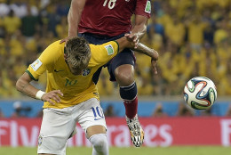 FOR USE AS DESIRED, YEAR END PHOTOS - FILE - Brazil's Neymar is fouled by Colombia's Juan Zuniga during the World Cup quarterfinal soccer match between Brazil and Colombia at the Arena Castelao in Fortaleza, Brazil, Friday, July 4, 2014. Brazil's team doctor says Neymar will miss the rest of the World Cup after breaking a vertebrae during the team's quarterfinal win over Colombia. (AP Photo/Manu Fernandez, File)