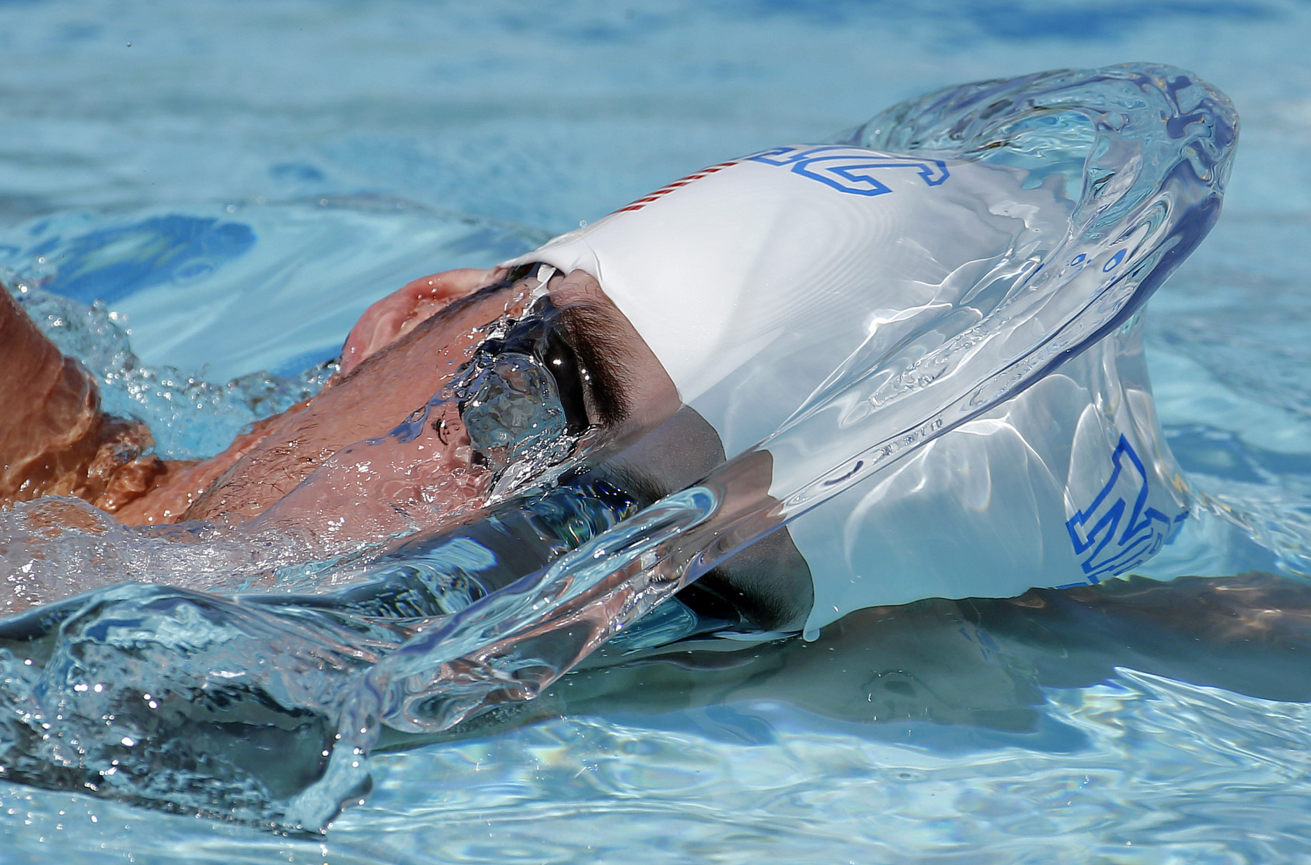 FOR USE AS DESIRED, YEAR END PHOTOS - FILE - Michael Phelps warms up prior to a 50-meter freestyle preliminary heat at the Arena Grand Prix swim event, Friday, April 25, 2014, in Mesa, Ariz. It is Phelps' second competitive event after a nearly two-year retirement. (AP Photo/Matt York, File)