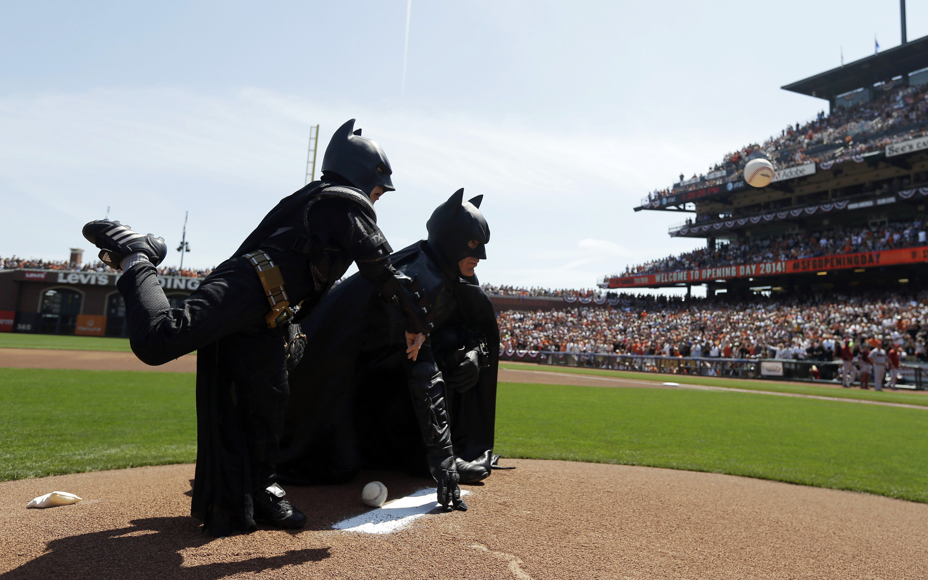 FOR USE AS DESIRED, YEAR END PHOTOS - FILE - Miles Scott, left, dressed as Batkid, throws the ceremonial first pitch next to Batman before an opening day baseball game between the San Francisco Giants and the Arizona Diamondbacks in San Francisco, Tuesday, April 8, 2014. On Nov. 15, 2013, Scott, a Northern California boy with leukemia, fought villains and rescued a damsel in distress as a caped crusader through The Greater Bay Area Make-A-Wish Foundation. (AP Photo/Eric Risberg, Pool, File)