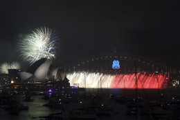 Fireworks explode over the Opera House and the Harbour Bridge during New Years Eve celebrations in Sydney, Australia, Wednesday, Dec. 31, 2014. Thousands of people crammed into Lady Macquaries Chair to watch the annual fireworks show. (AP Photo/Rob Griffith)