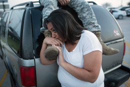 FOR USE AS DESIRED, YEAR END PHOTOS - FILE - Lucy Hamlin and her husband, Spc. Timothy Hamlin, wait for permission to re-enter the Fort Hood military base, where they live, following a shooting on the base, Wednesday, April 2, 2014, in Fort Hood, Texas. (AP Photo/ Tamir Kalifa, File)