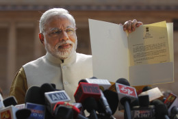 FOR USE AS DESIRED, YEAR END PHOTOS - FILE - India's next prime minister and Hindu nationalist Bharatiya Janata Party (BJP) leader Narendra Modi displays the letter from the Indian President inviting him to form the new government, outside the Presidential Palace in New Delhi, India, Tuesday, May 20, 2014. Modi met with President Pranab Mukherjee after he was formally chosen by his party as the next prime minister, just days after a resounding victory in national elections. (AP Photo/Altaf Qadri, File)