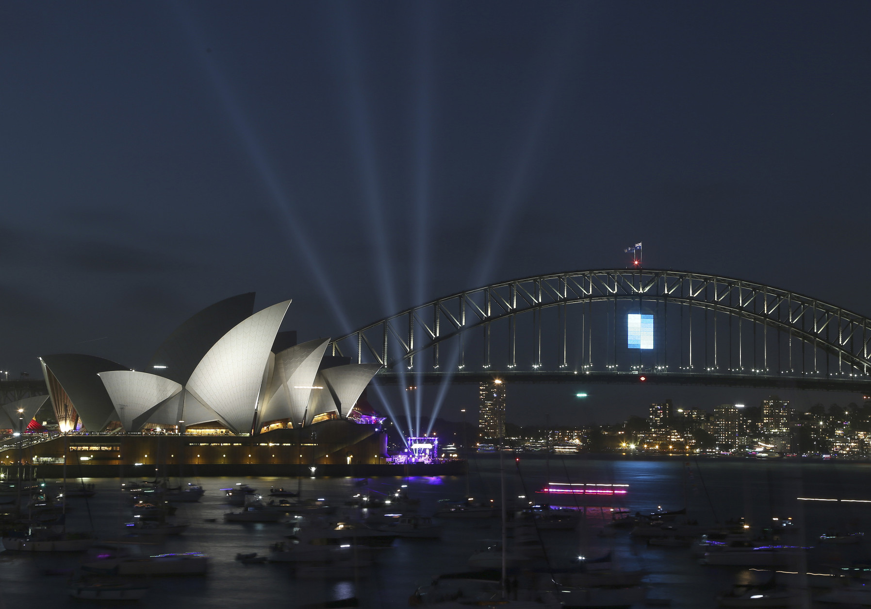The Sydney Opera House and the Harbour Bridge are seen during New Years Eve celebrations in Sydney, Australia, Wednesday, Dec. 31, 2014. Thousands of people crammed into Lady Macquaries Chair to watch the annual fireworks show. (AP Photo/Rob Griffith)