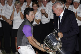 FOR USE AS DESIRED, YEAR END PHOTOS - FILE - Rory McIlroy, of Northern Ireland, catches the Wanamaker Trophy from PGA of America president Ted Bishop after winning the PGA Championship golf tournament at Valhalla Golf Club on Sunday, Aug. 10, 2014, in Louisville, Ky. (AP Photo/David J. Phillip, File)