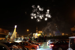 A Iraqi Crowds cheer as the countdown and fireworks begin during a New Year's Day celebration at Firdous Square in Baghdad, Iraq, Wednesday, Dec. 31, 2014. (AP Photo/Hadi Mizban)