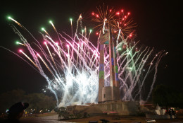 Fireworks begin during a New Year's eve countdown at the Quezon Memorial Circle in suburban Quezon city, north of Manila, Philippines on Wednesday, Dec. 31, 2014. (AP Photo/Aaron Favila)