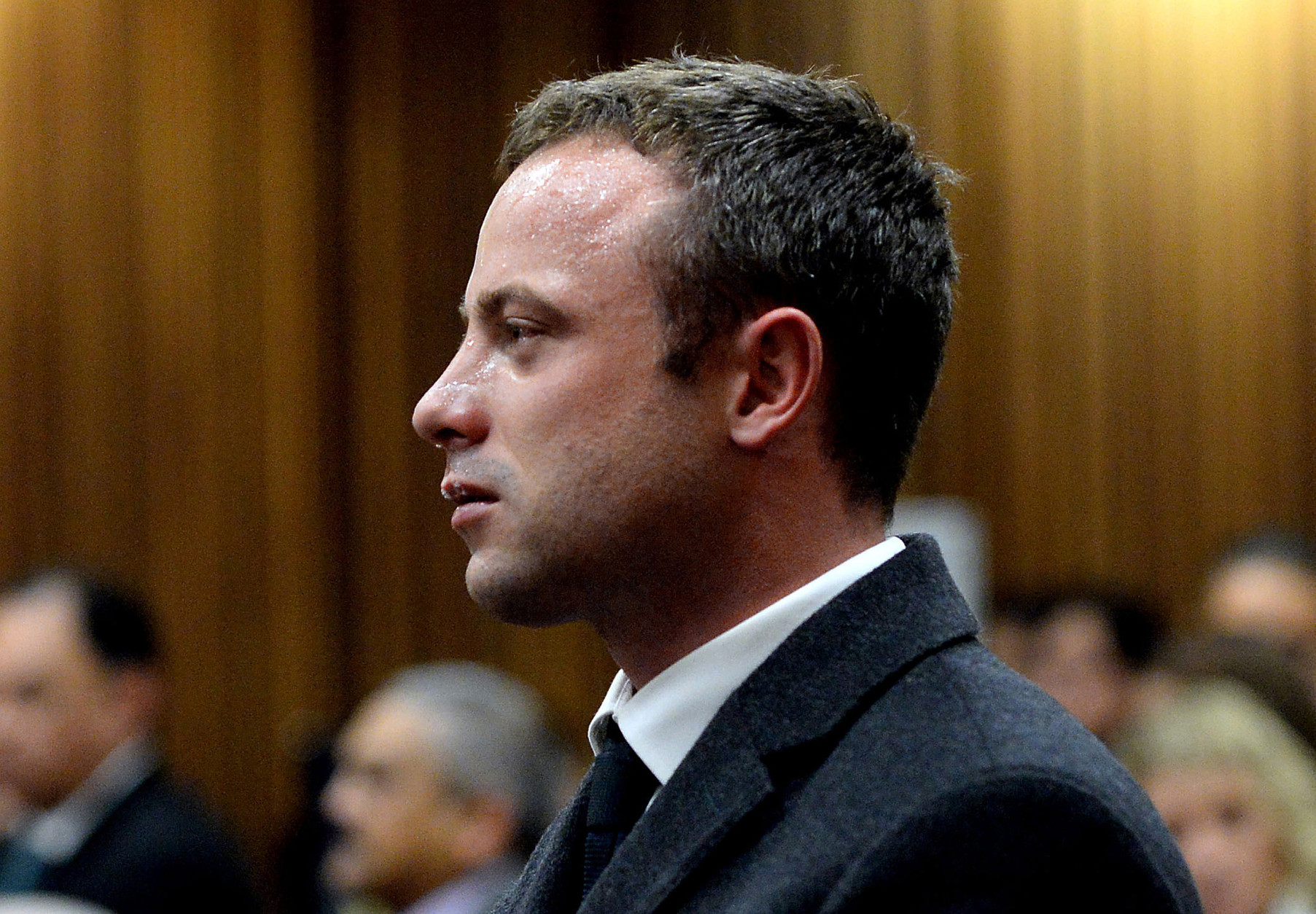 FOR USE AS DESIRED, YEAR END PHOTOS - FILE - In this photo taken Monday March 10, 2014, Oscar Pistorius cries as he listens to cross questioning about the events surrounding the shooting death of his girlfriend Reeva Steenkamp, in court during his trial in Pretoria, South Africa. Pistorius was charged with the shooting death of Steenkamp, on Valentines Day in 2013. (AP Photo/Bongiwe Mchunu, File Pool)