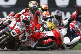 FOR USE AS DESIRED, YEAR END PHOTOS - FILE - Luca Grunwald of Germany, crashes and falls on his Kalex KTM, right, colliding with  Alessandro Tonucci of Italy on his Mahindra, left, and Juanfran Guevara on his Kalex KTM, centre, during the Moto3 Race of the Dutch Grand Prix, in Assen, northern Netherlands, Saturday June 28, 2014. (AP Photo/Vincent Jannink, File)
