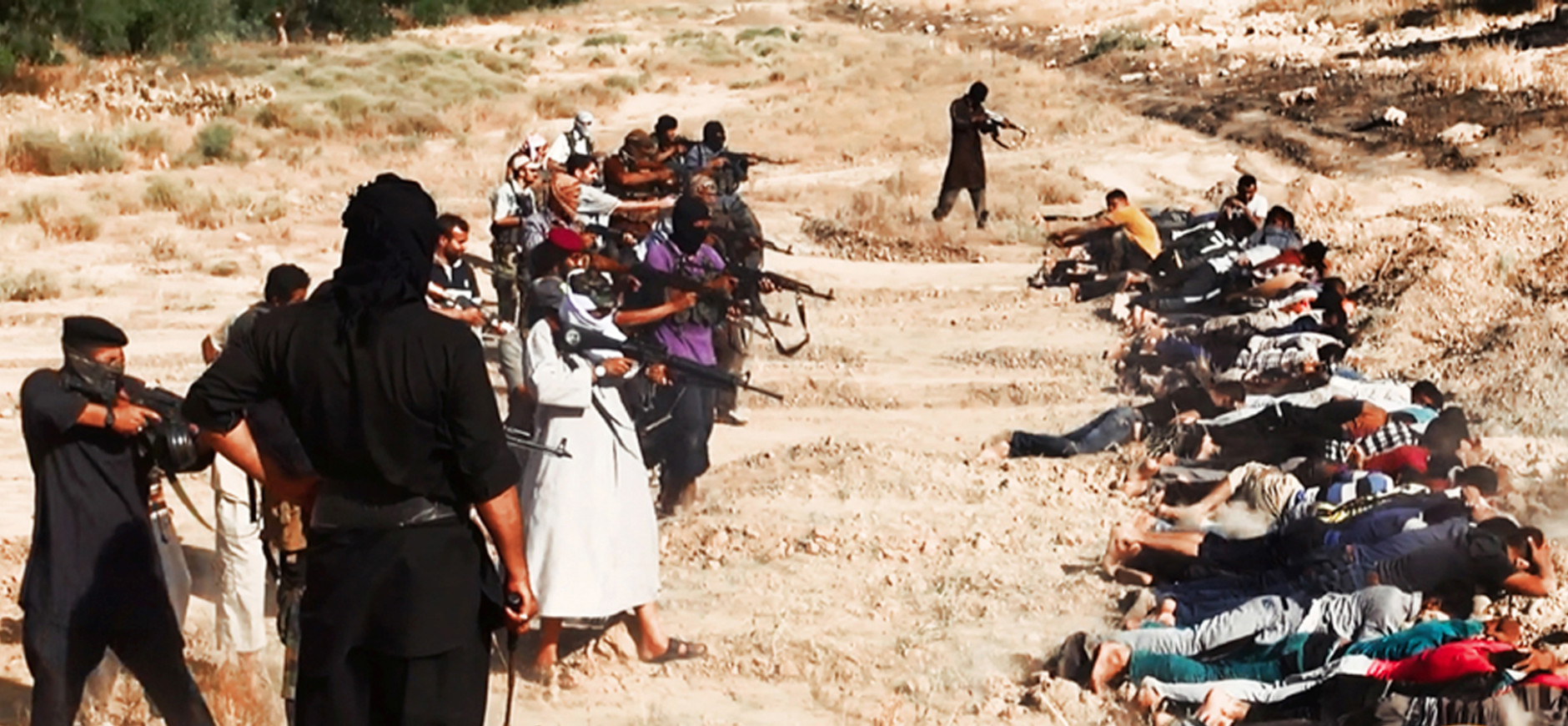 FOR USE AS DESIRED, YEAR END PHOTOS - FILE - This image posted on a militant website on Saturday, June 14, 2014, which has been verified and is consistent with other AP reporting, appears to show militants from the al-Qaida-inspired Islamic State of Iraq and the Levant (ISIL) taking aim at captured Iraqi soldiers wearing plain clothes after taking over a base in Tikrit, Iraq.  (AP Photo via militant website, File)