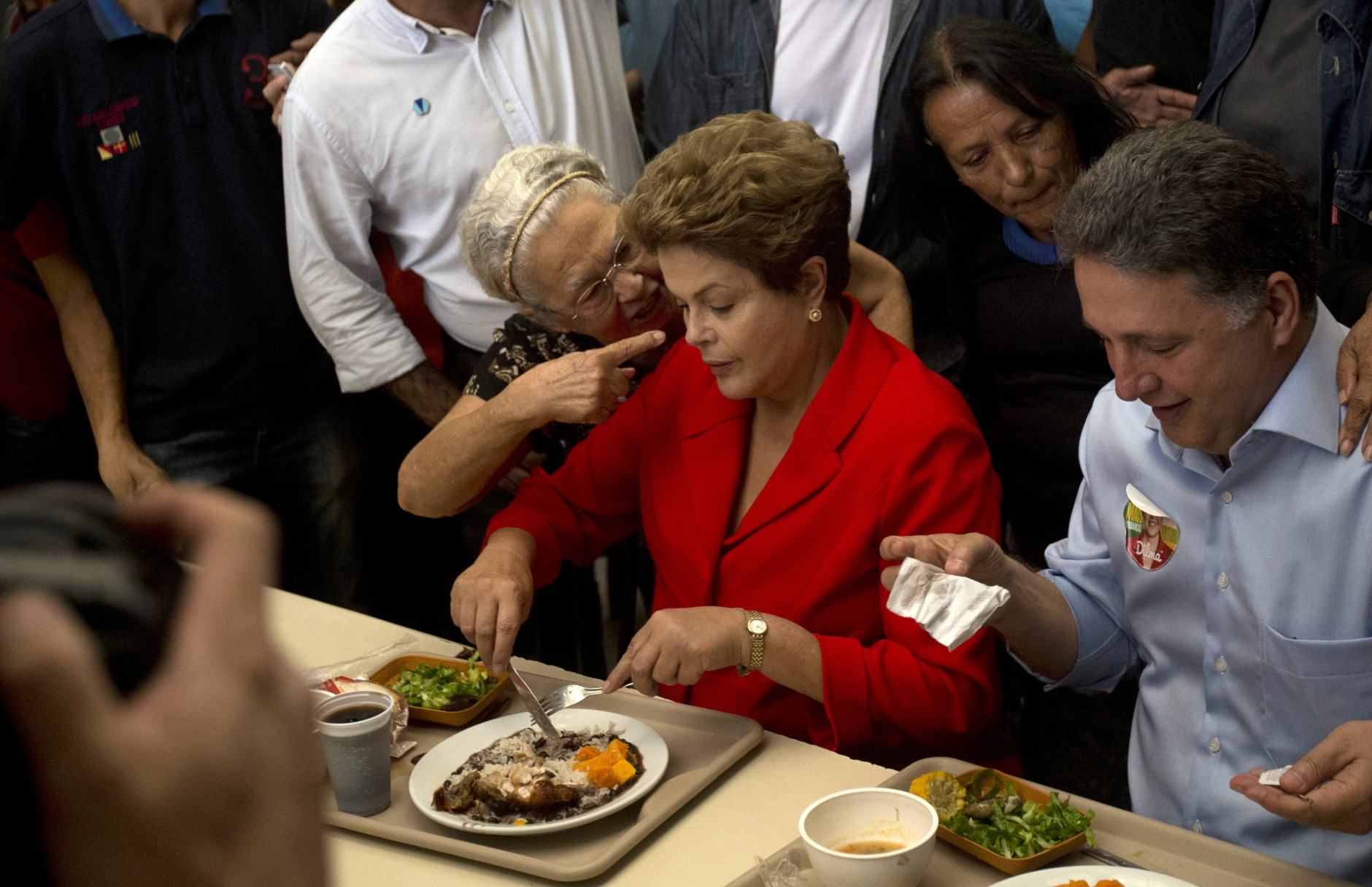FOR USE AS DESIRED, YEAR END PHOTOS - FILE - A woman talks to Brazil's President Dilma Rousseff, who is running for reelection for the Workers Party (PT), as Rousseff makes a campaign stop at a popular restaurant in Rio de Janeiro, Brazil, Wednesday, Aug. 27, 2014.  (AP Photo/Silvia Izquierdo, File)