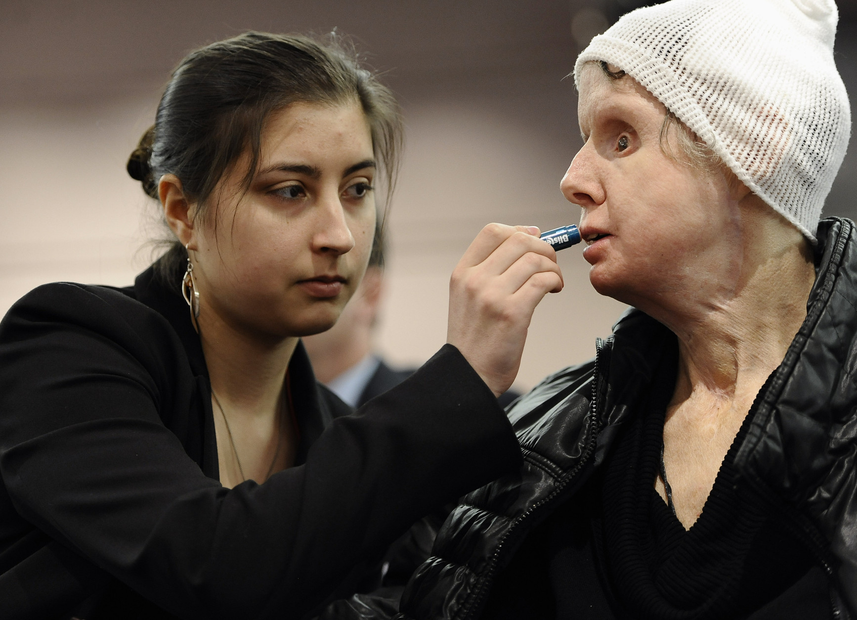 FOR USE AS DESIRED, YEAR END PHOTOS - FILE - Briana Nash, left, helps her mother Charla Nash, apply lip balm before speaking to Connecticut legislators at a public hearing at the Legislative Office Building, Friday, March 21, 2014, in Hartford, Conn. Nash was mauled by a friend's chimpanzee in 2009.  (AP Photo/Jessica Hill, File)