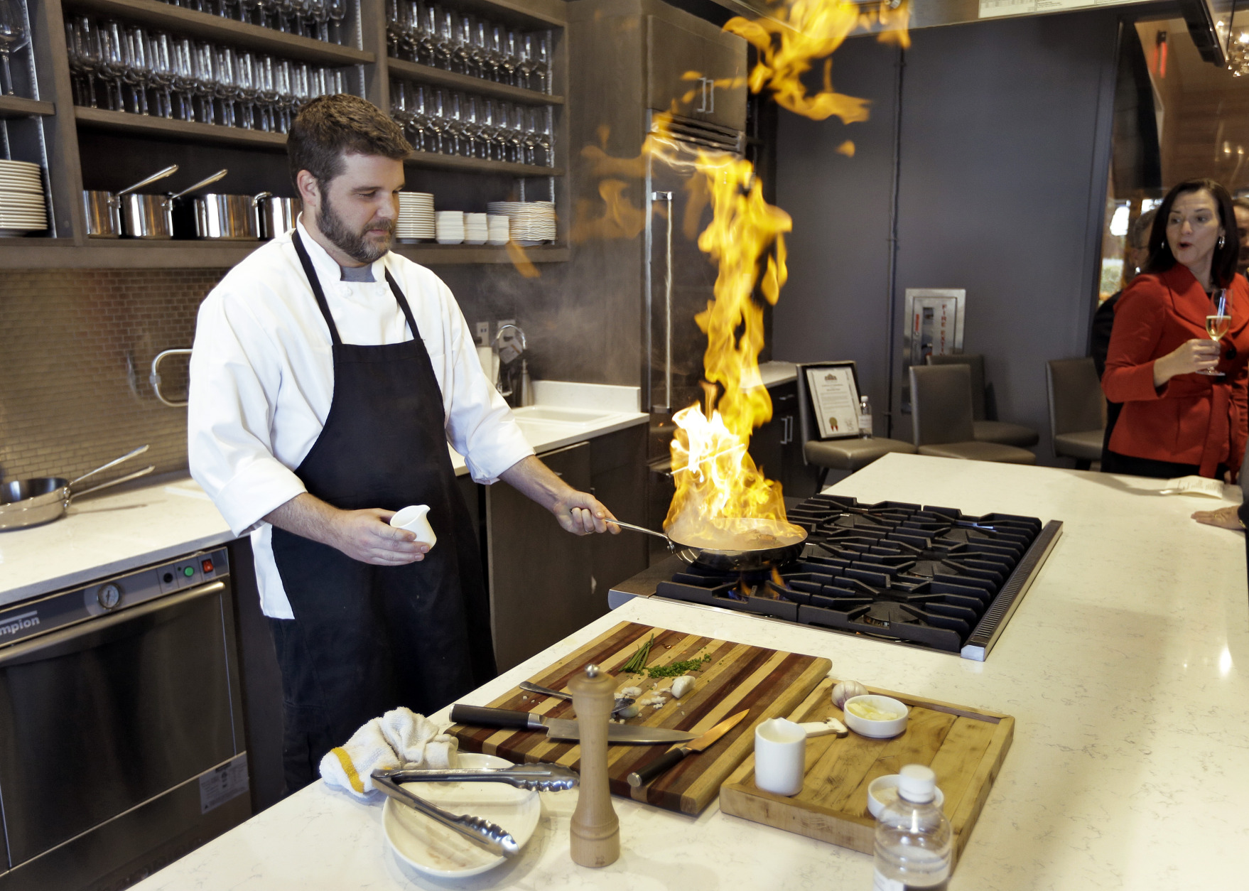 This Dec. 17, 2013 photo shows Executive Chef Chad Johnson cooking a steak during a tour of the new Epicurean Hotel in Tampa, Fla. Tampas newest hotel, which opened this week, is focused on food, with a restaurant, bakery, culinary theater, wine store and cooking classes onsite. (AP Photo/Chris O'Meara)