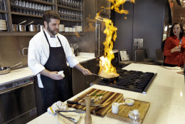 This Dec. 17, 2013 photo shows Executive Chef Chad Johnson cooking a steak during a tour of the new Epicurean Hotel in Tampa, Fla. Tampas newest hotel, which opened this week, is focused on food, with a restaurant, bakery, culinary theater, wine store and cooking classes onsite. (AP Photo/Chris O'Meara)