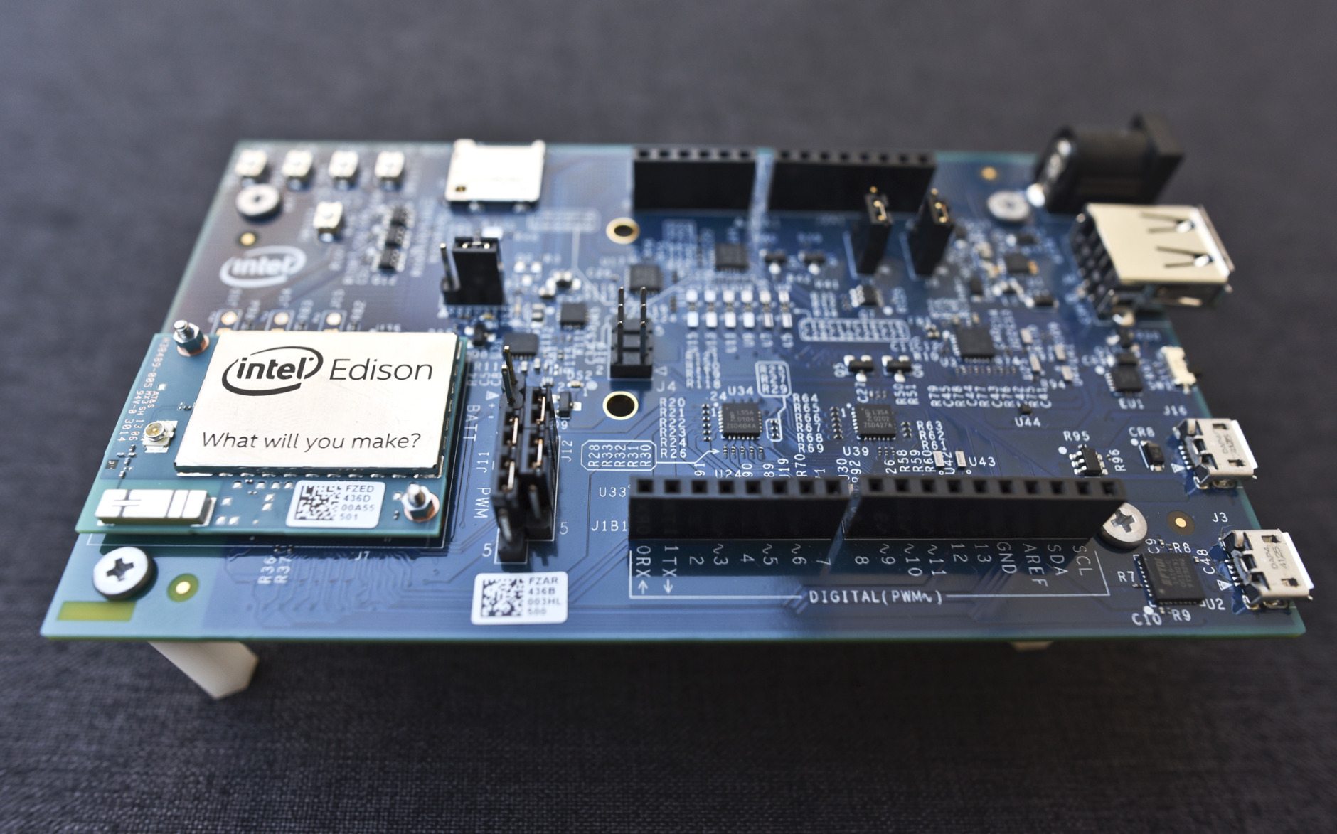 This Wednesday, Dec. 10, 2014 photo shows the Intel Edison, a small programmable computer the size of an SD memory card, seated on an electronics expansion board, in Decatur, Ga. The Edison has both Wi-Fi and Bluetooth technology built in, as well as a full distribution of the Linux operating system. (AP Photo/Ron Harris)