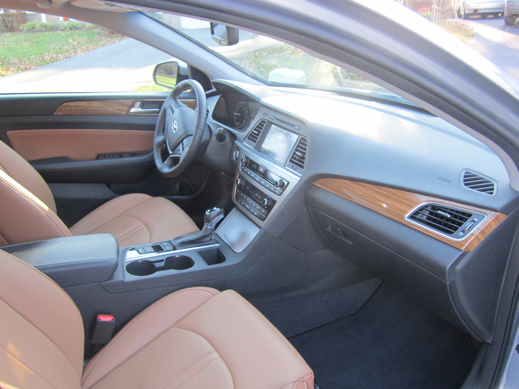 The interior color scheme of black and brown really works; the wood trim is a nice touch, too. The leather seats are heated and cooled and are comfy for about four hours. (WTOP/Mike Parris)