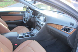 The interior color scheme of black and brown really works; the wood trim is a nice touch, too. The leather seats are heated and cooled and are comfy for about four hours. (WTOP/Mike Parris)