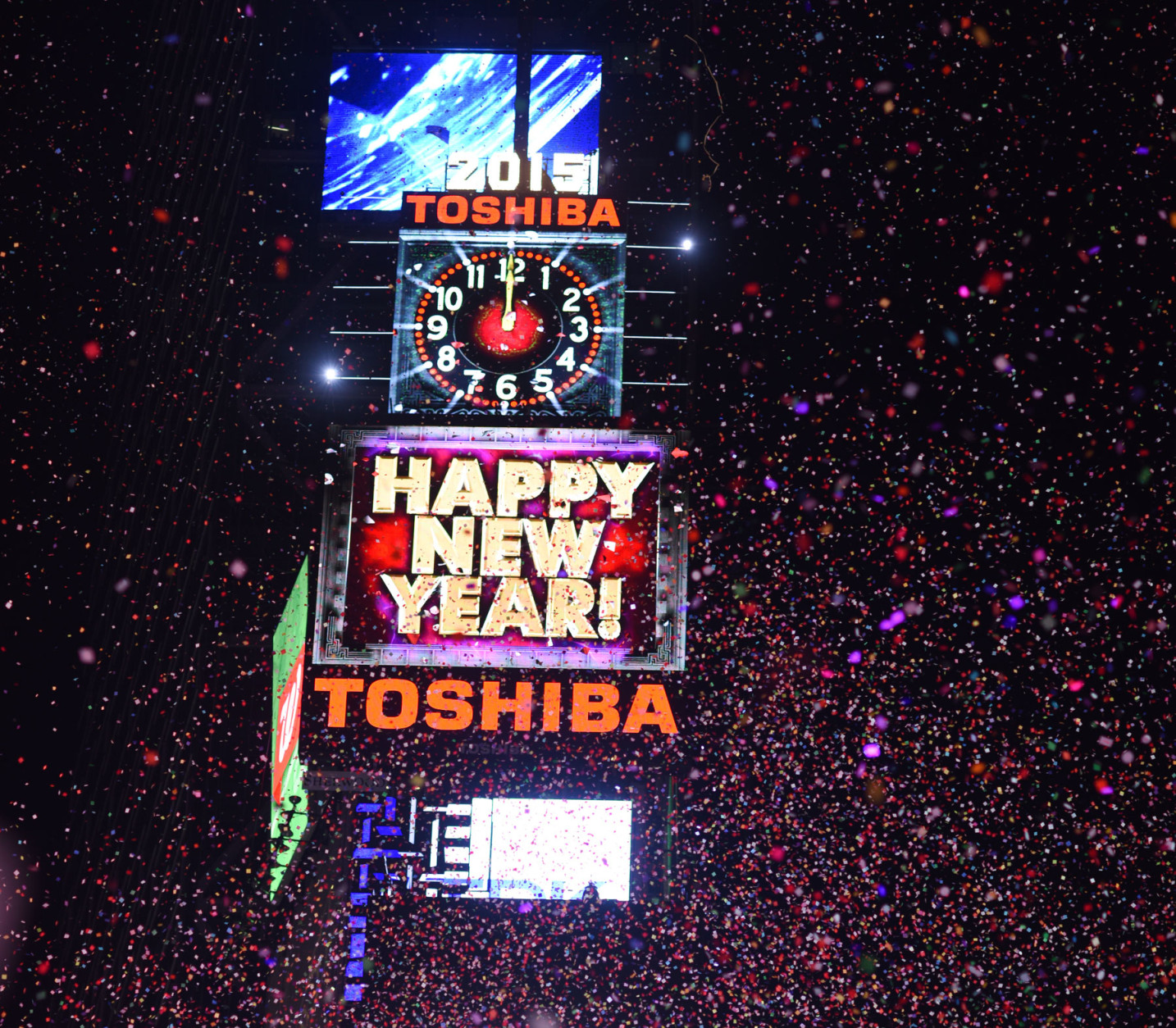 People cheer as the ball drops at midnight in Times Square on January 1, 2015 in New York City. An estimated one million people from around the world are expected to pack Times Square to ring in 2015. (Photo by Andrew Theodorakis/Getty Images)