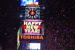 People cheer as the ball drops at midnight in Times Square on January 1, 2015 in New York City. An estimated one million people from around the world are expected to pack Times Square to ring in 2015. (Photo by Andrew Theodorakis/Getty Images)