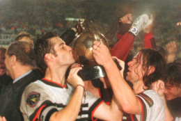 John Harkes and Jeff Agoos of DC United hoist the Alan I Rothenberg Cup after their team defeated the Los Angeles Galaxy in the Major League Soccer MLS Championship game at Foxboro Stadium in Foxboro, Massachusetts. 