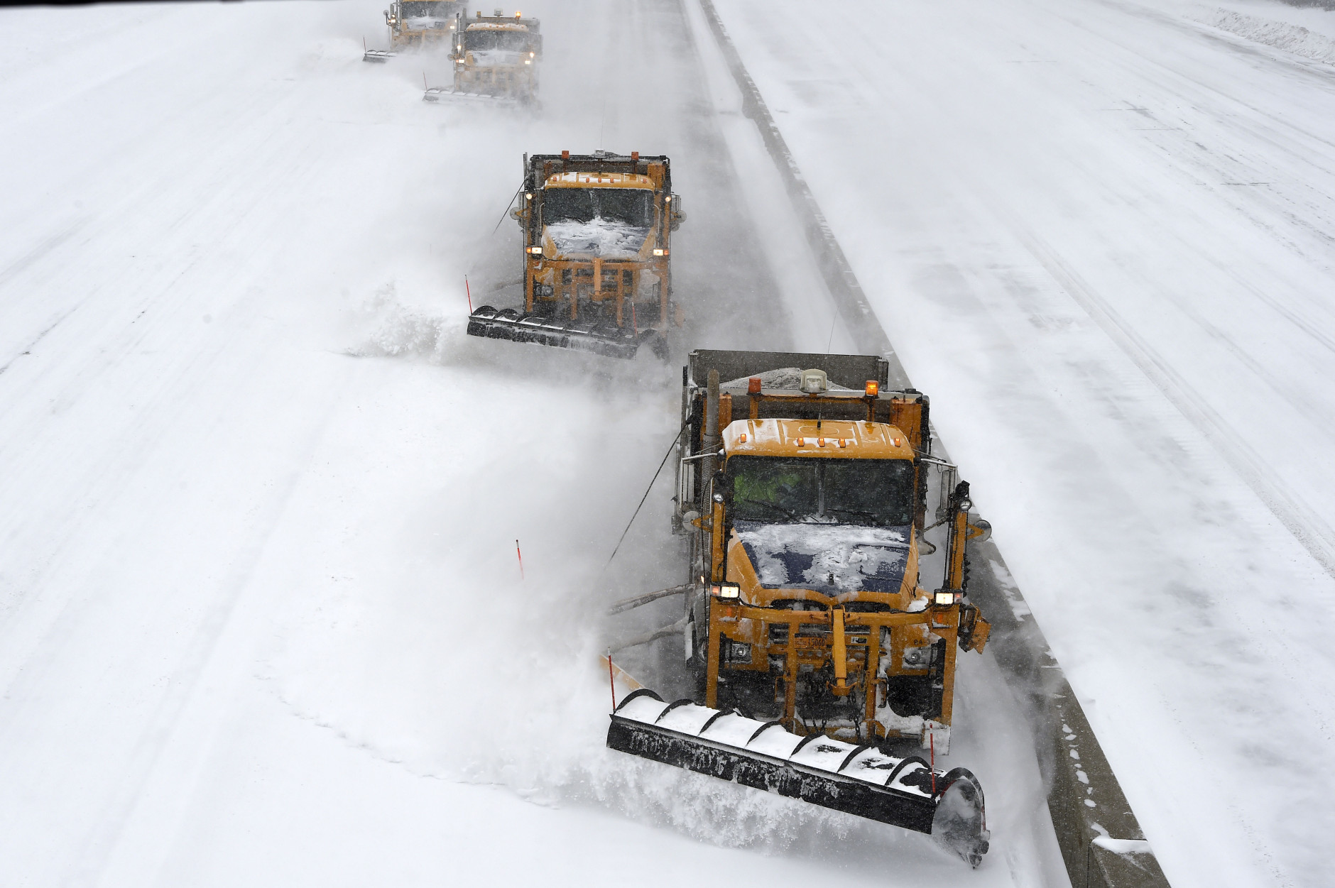 New York State Department of Transportation plows clear snow off the Long Island Expressway after it was reopened on Tuesday, Jan. 27, 2015, in Melville, N.Y. The Expressway and other roads were closed after a blizzard hit the New York area overnight into this morning. (AP Photo/Kathy Kmonicek)(AP Photo/Kathy Kmonicek)