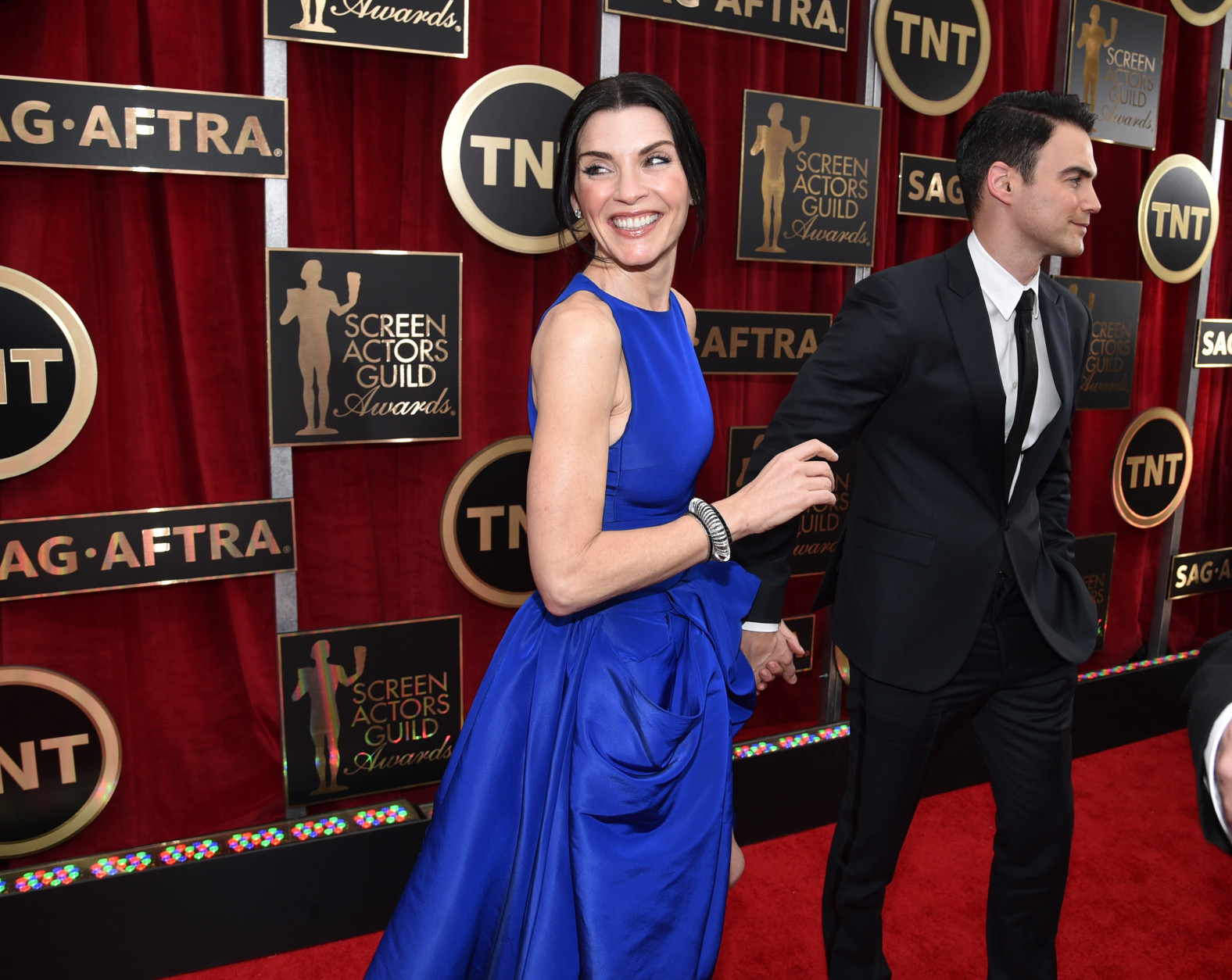 Julianna Margulies, left, and Keith Lieberthal arrive at the 21st annual Screen Actors Guild Awards at the Shrine Auditorium on Sunday, Jan. 25, 2015, in Los Angeles. (Photo by John Shearer/Invision/AP)