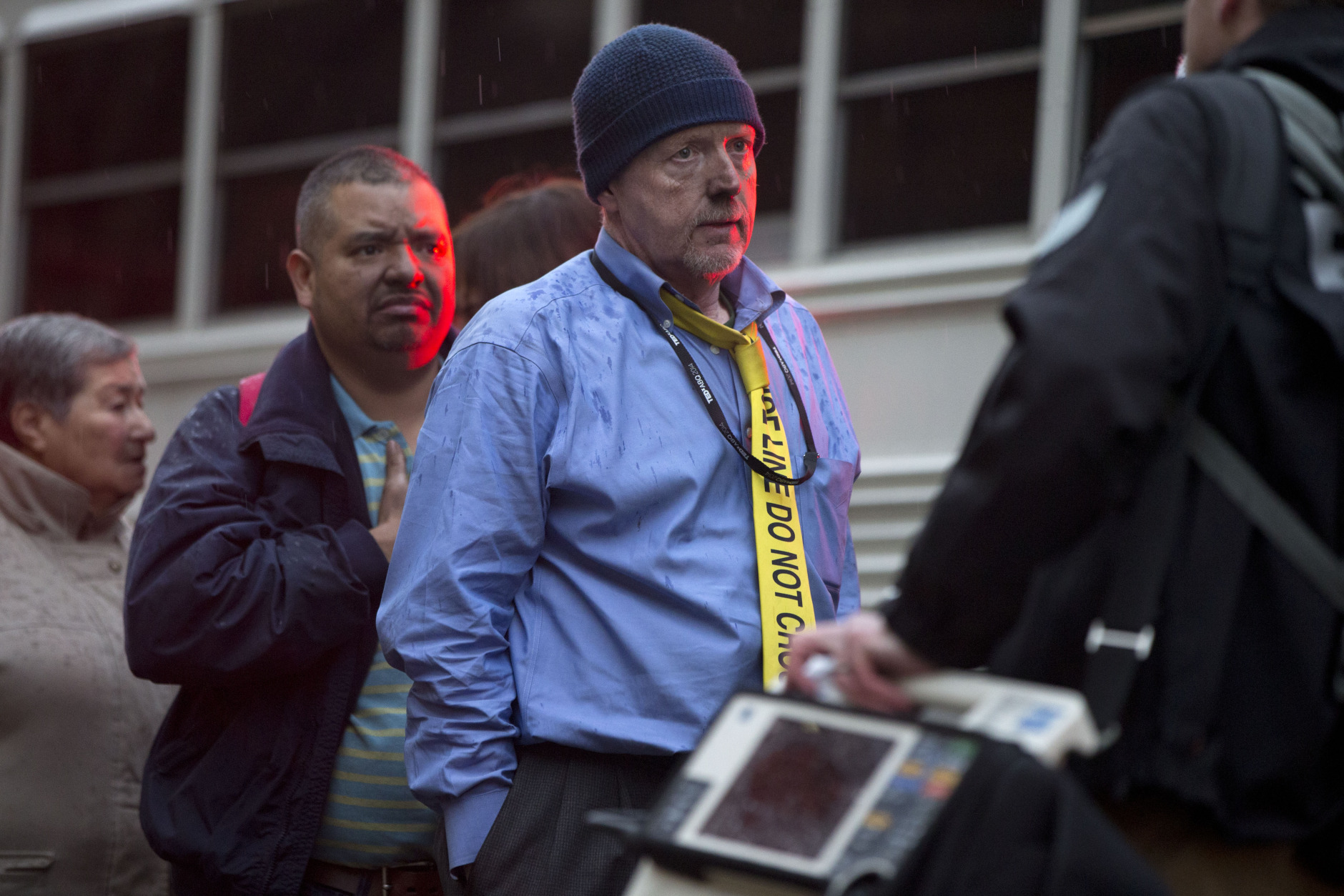 A man with a tie that says "Police Line Do Not Cross" waits in a triage line after being evacuated from a smoke filled Metro subway tunnel in Washington, Monday, Jan. 12, 2015. Metro officials say one of the busiest stations in downtown Washington has been evacuated because of smoke.  Authorities say the source of the smoke is unknown.  (AP Photo/Jacquelyn Martin)