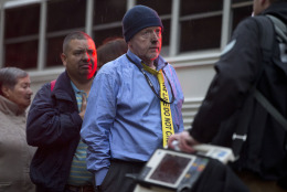 A man with a tie that says "Police Line Do Not Cross" waits in a triage line after being evacuated from a smoke filled Metro subway tunnel in Washington, Monday, Jan. 12, 2015. Metro officials say one of the busiest stations in downtown Washington has been evacuated because of smoke.  Authorities say the source of the smoke is unknown.  (AP Photo/Jacquelyn Martin)
