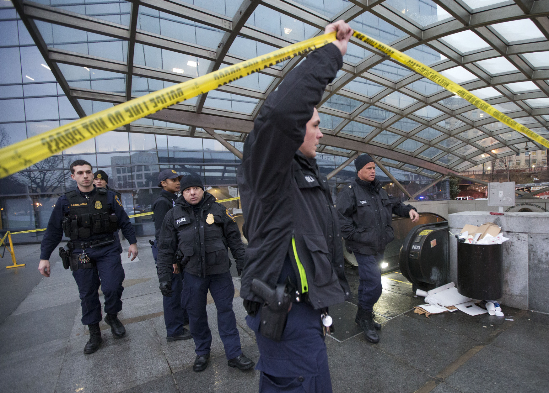 Metro Transit Police officers secure the entrance to  LEnfant Plaza Station in Washington, Monday, Jan. 12, 2015. Metro officials say one of the busiest stations in downtown Washington has been evacuated because of smoke.  Authorities say the source of the smoke is unknown.   (AP Photo/Manuel Balce Ceneta)