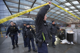 Metro Transit Police officers secure the entrance to  LEnfant Plaza Station in Washington, Monday, Jan. 12, 2015. Metro officials say one of the busiest stations in downtown Washington has been evacuated because of smoke.  Authorities say the source of the smoke is unknown.   (AP Photo/Manuel Balce Ceneta)