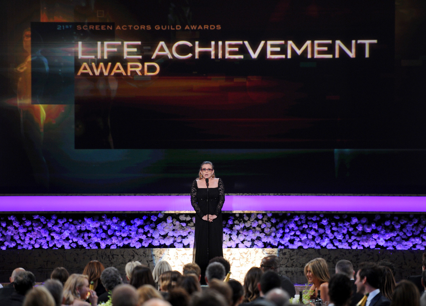 Carrie Fisher presents the life achievement award on stage at the 21st annual Screen Actors Guild Awards at the Shrine Auditorium on Sunday, Jan. 25, 2015, in Los Angeles. (Photo by Vince Bucci/Invision/AP)
