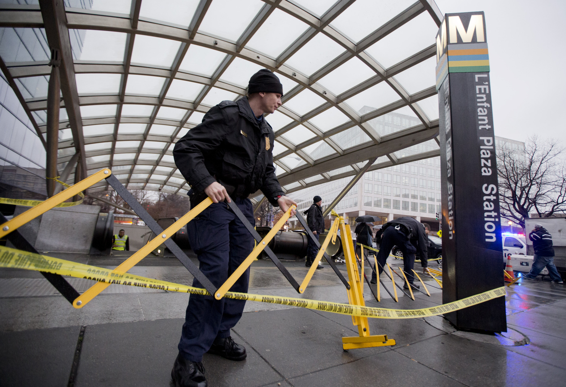Metro Transit Police officers secure the entrance to L'Enfant Plaza Station in Washington, Monday, Jan. 12, 2015, following an evacuation. (AP Photo/Manuel Balce Ceneta)