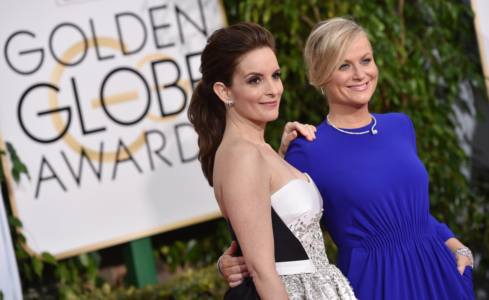Tina Fey, left, and Amy Poehler arrive at the 72nd annual Golden Globe Awards at the Beverly Hilton Hotel on Sunday, Jan. 11, 2015, in Beverly Hills, Calif. (Photo by John Shearer/Invision/AP)
