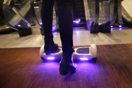 A woman rides an IO Hawk, a self-balancing motorized personal transporter at the International CES, Monday, Jan. 5, 2015, in Las Vegas. The world's largest annual trade show officially opens Tuesday. (AP Photo/Jae C. Hong)