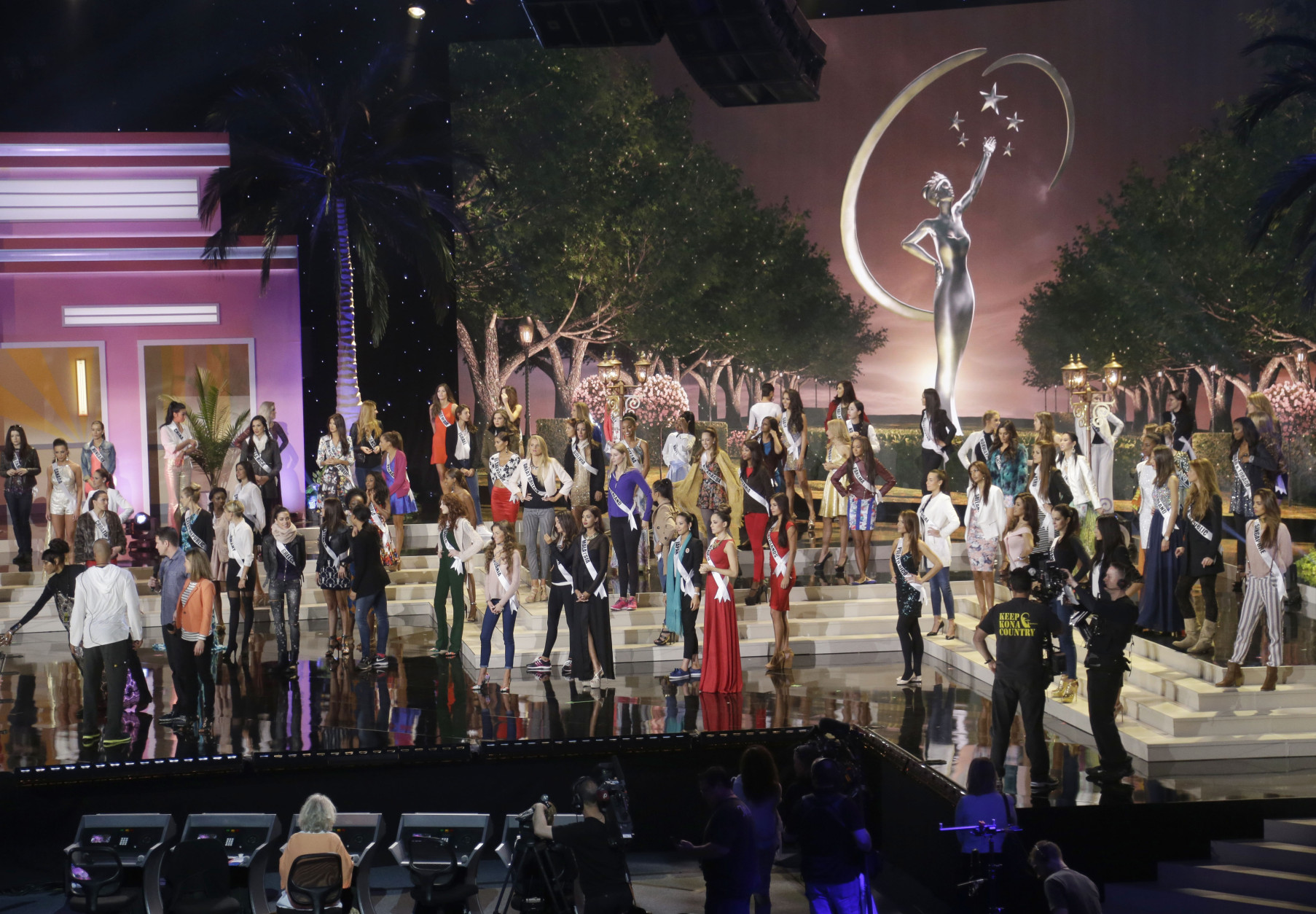 Miss Universe contestants stand in place during a break in rehearsals, Saturday, Jan. 24, 2015, at Florida International University in Miami. The Miss Universe pageant will be held Jan. 25, in Miami. (AP Photo/Wilfredo Lee)