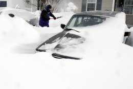 Paul Baxter digs his cars out of drifted snow after a winter storm, Tuesday, Jan. 27, 2015, in Marlborough, Mass. A storm packing blizzard conditions spun up the East Coast early Tuesday, pounding parts of coastal New Jersey northward through Maine with high winds and heavy snow. (AP Photo/Bill Sikes)
