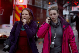 A woman coughs hard as she and another woman walk past an evacuation of people from a smoke filled Metro subway tunnel in Washington, Monday, Jan. 12, 2015. Metro officials say one of the busiest stations in downtown Washington has been evacuated because of smoke.  Authorities say the source of the smoke is unknown.   (AP Photo/Jacquelyn Martin)