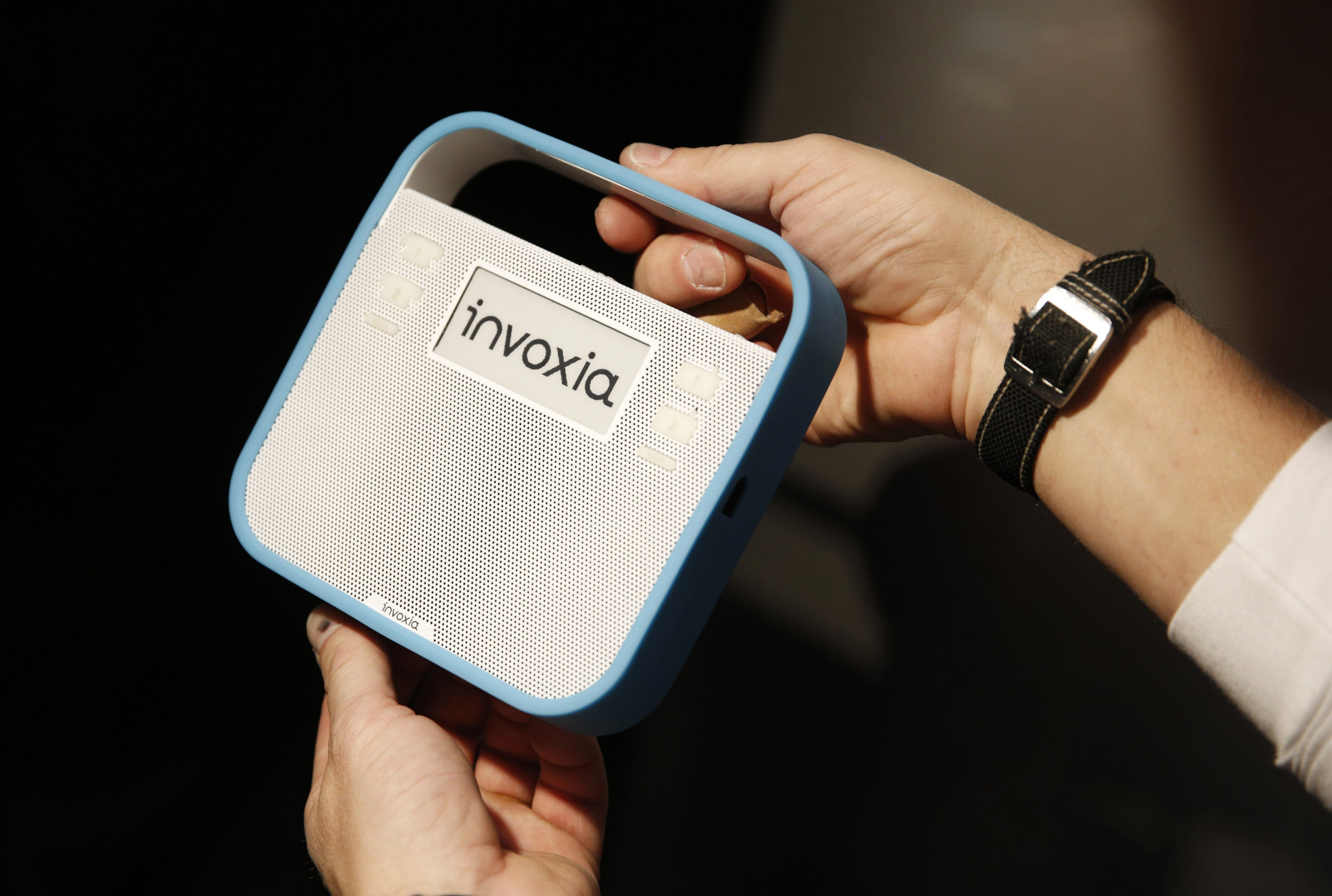 A man holds up the Invoxia Triby at CES Unveiled, a media preview event for CES International, Sunday, Jan. 4, 2015, in Las Vegas. The device can make phone calls, receive digital messages and play music. (AP Photo/John Locher)