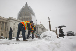 Workers clear the sidewalks of snow outside the U.S. Capitol, in Washington, Tuesday, Jan. 6, 2015. (AP Photo/Pablo Martinez Monsivais )