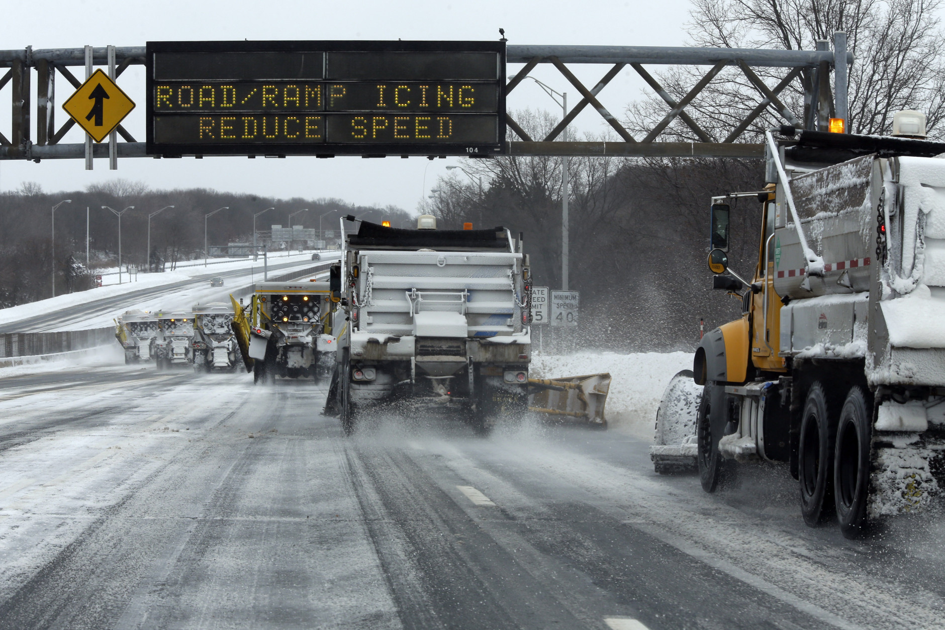 Snow plows clear the Long Island Expressway, Tuesday, Jan. 27, 2015 in Central Islip, N.Y.  A storm packing blizzard conditions spun up the East Coast early Tuesday, pounding coastal eastern Long Island into Maine with high winds and heavy snow. (AP Photo/Mary Altaffer)