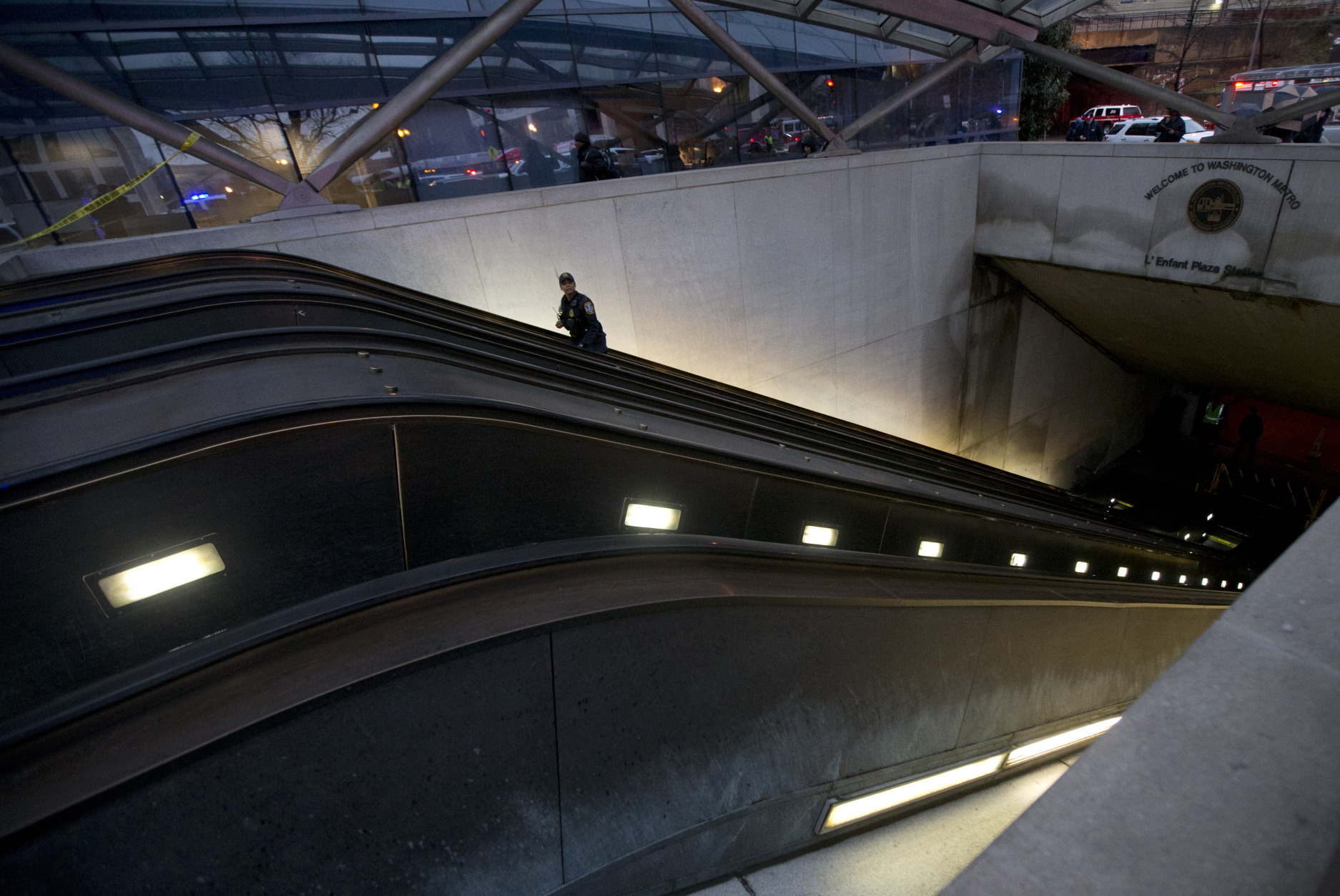 A Metro Transit Police officer walks up the escalator at LEnfant Plaza Station in Washington, Monday, Jan. 12, 2015, following an evacuation. Metro officials say one of the busiest stations in downtown Washington has been evacuated because of smoke.  Authorities say the source of the smoke is unknown.   (AP Photo/Manuel Balce Ceneta)