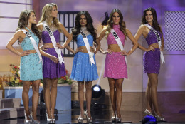 Top 15 finalists Miss USA Nia Sanchez, left, Miss France Camille Cerf, Miss India Noyonita Lodh, Miss Italy Valentina Bonariva and Miss Colombia Paulina Vega, pose on stage during the Miss Universe pageant in Miami, Sunday, Jan. 25, 2015. (AP Photo/Wilfredo Lee)
